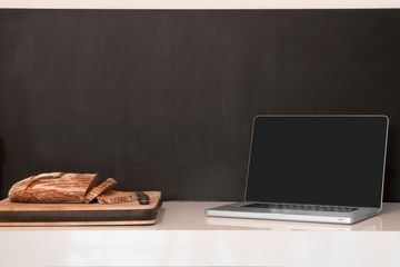 laptop wineglass and bread loaf on counter picture id481634329