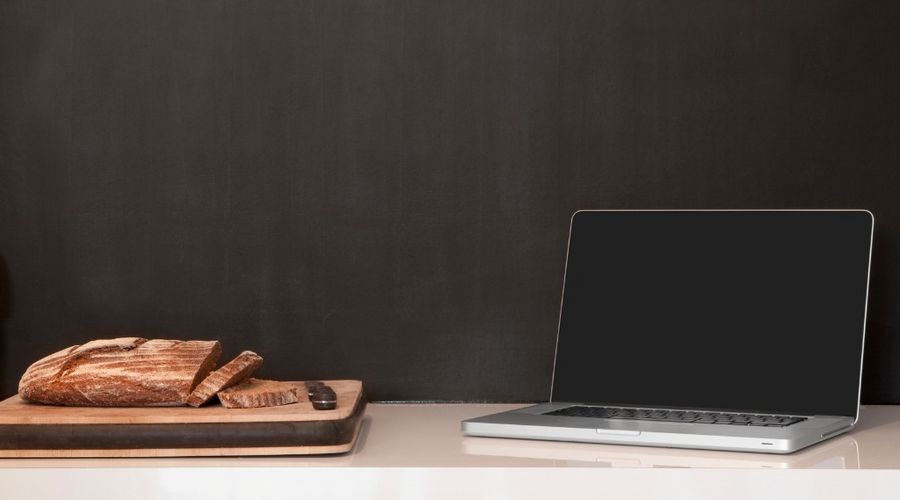 laptop wineglass and bread loaf on counter picture id481634329